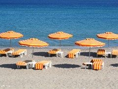 small-Greece. Kos island. Kefalos beach. Orange chairs and umbrellas on the beach1