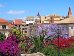 small-View of a mediterranean town with flowers on the foreground. Corfu, Greece